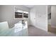 Minimalist office space featuring a glass-topped desk, neutral color scheme, and modern window at 1810 Julian St # 105, Denver, CO 80204