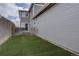 Backyard space featuring lush artificial turf and a convenient side entrance, ideal for easy access at 2283 S Bannock St, Denver, CO 80223