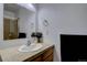 Bathroom with tiled shower, large mirror, and a wooden vanity with ample counter space at 2283 S Bannock St, Denver, CO 80223