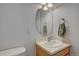 Cozy bathroom featuring an oval mirror, a sink, and a light wood vanity at 2283 S Bannock St, Denver, CO 80223