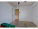 Empty bedroom with neutral carpeting with a closet and a door into another room at 2283 S Bannock St, Denver, CO 80223