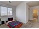 Bright bedroom featuring a window and closet adjacent to a doorway with carpeted flooring at 2283 S Bannock St, Denver, CO 80223