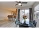 Cozy dining area with a glass table, modern chairs, and sliding doors to the outdoor space at 2283 S Bannock St, Denver, CO 80223