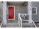 Inviting front porch with a bright red door, classic white columns, and a cozy seating area at 2283 S Bannock St, Denver, CO 80223