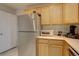 Kitchen features stainless steel fridge, light wood cabinets and modern appliances at 2283 S Bannock St, Denver, CO 80223
