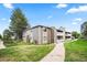 Exterior view of condo building with landscaped grounds and walking path at 18133 E Kentucky Ave # 203, Aurora, CO 80017