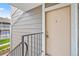 Exterior shot of the unit's front door with secure lock and railing at 18133 E Kentucky Ave # 203, Aurora, CO 80017
