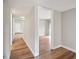 Hallway with light gray walls, white trim, and wood flooring at 18133 E Kentucky Ave # 203, Aurora, CO 80017