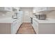 Modern kitchen featuring white cabinets, updated appliances and hardware at 18133 E Kentucky Ave # 203, Aurora, CO 80017