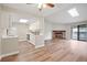 Open-concept living space with hardwood floors, fireplace, and adjacent kitchen at 18133 E Kentucky Ave # 203, Aurora, CO 80017