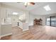 Open-concept living space with hardwood floors, fireplace, and adjacent kitchen at 18133 E Kentucky Ave # 203, Aurora, CO 80017