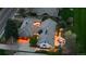 Aerial view of home showcasing a three car garage, patio, and outdoor fireplace at 18 Club Ln, Littleton, CO 80123