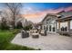 Spacious backyard with a stone fire pit surrounded by comfortable seating, ideal for outdoor gatherings and relaxation at 18 Club Ln, Littleton, CO 80123