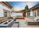 Beautiful outdoor living space with a hot tub, fireplace, and comfortable seating at 18 Club Ln, Littleton, CO 80123