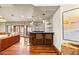 Cozy wet bar featuring seating for 4 and hardwood floors at 18 Club Ln, Littleton, CO 80123