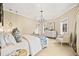 Cozy bedroom featuring a window seat, chandelier, and a comfortable bed at 18 Club Ln, Littleton, CO 80123