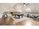 Spacious bonus room with skylights, pool table, and comfortable seating for recreation and relaxation at 18 Club Ln, Littleton, CO 80123