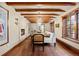 Bright dining room with hardwood floors, exposed beams, a fireplace, and natural lighting at 18 Club Ln, Littleton, CO 80123