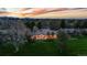 Expansive estate with manicured lawn and outdoor living spaces at twilight at 18 Club Ln, Littleton, CO 80123