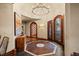 Grand foyer featuring elegant tile floors, decorative doors, and a statement chandelier at 18 Club Ln, Littleton, CO 80123