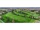Picturesque aerial view of a lush green golf course featuring manicured fairways, mature trees, and challenging sand traps at 18 Club Ln, Littleton, CO 80123