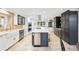 Spacious kitchen featuring custom cabinetry, stainless steel appliances, and a large center island at 18 Club Ln, Littleton, CO 80123