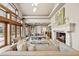 Spacious living room featuring a fireplace and large windows allowing plenty of natural light at 18 Club Ln, Littleton, CO 80123