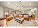 Open living room with a wet bar and backyard views at 18 Club Ln, Littleton, CO 80123