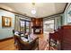 Cozy office space with hardwood floors, a vintage rug, and natural lighting at 18 Club Ln, Littleton, CO 80123