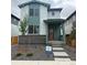 Charming two-story home with a red front door and a modern, landscaped front yard at 21144 E 63Rd Dr, Aurora, CO 80019