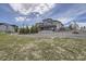 Expansive backyard featuring a multi-level deck, lush lawn, and professional landscaping at 8625 E 125Th Ct, Thornton, CO 80602