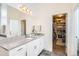 Bathroom featuring a granite countertop vanity and a walk-in closet at 8625 E 125Th Ct, Thornton, CO 80602