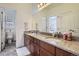 Bathroom with double vanity, granite countertops, and neutral decor at 8625 E 125Th Ct, Thornton, CO 80602