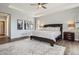 Serene bedroom with a tray ceiling, ceiling fan, and dark wood furniture at 8625 E 125Th Ct, Thornton, CO 80602