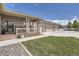 Attractive home with a covered porch, stone details, a three-car garage, and a well-maintained lawn at 8625 E 125Th Ct, Thornton, CO 80602