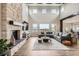 Stunning living room with a stone fireplace, hardwood floors, and soaring ceilings with an abundance of natural light at 8625 E 125Th Ct, Thornton, CO 80602