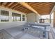 Covered patio with a seating area and a modern picnic table and benches, perfect for outdoor entertaining at 8625 E 125Th Ct, Thornton, CO 80602