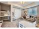Bright playroom featuring a cozy sofa, play area, and a built-in desk at 8625 E 125Th Ct, Thornton, CO 80602
