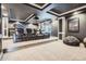 Home theater with tiered seating, projector screen, and dark, cozy ambiance at 8625 E 125Th Ct, Thornton, CO 80602