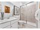 Modern bathroom features a glass-enclosed shower, a white vanity, and tasteful decor at 3381 N Denali St, Aurora, CO 80019