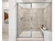 Modern bathroom with glass-enclosed tiled shower and built in bench at 3381 N Denali St, Aurora, CO 80019