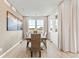 Bright dining room with large windows and seating for six at 3381 N Denali St, Aurora, CO 80019