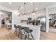 Contemporary kitchen featuring white cabinetry, stainless steel appliances, and a quartz countertop island at 3381 N Denali St, Aurora, CO 80019
