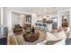 Bright and open living area connected to a modern kitchen with stainless steel appliances at 3381 N Denali St, Aurora, CO 80019