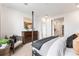Bedroom featuring carpet, view into bathroom, furniture, and neutral walls at 3381 N Denali St, Aurora, CO 80019