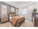 Inviting bedroom featuring a woven headboard, soft lighting, and neutral colors for relaxation at 3381 N Denali St, Aurora, CO 80019