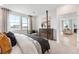 Bedroom featuring neutral walls, carpet, four poster bed, and bright windows at 3381 N Denali St, Aurora, CO 80019