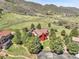 Aerial view of the property showcasing the home with a pool and surrounding landscape at 10991 Expedition, Littleton, CO 80125