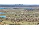 Stunning aerial view of the community showcasing the landscape, water views, and the city skyline in the distance at 10991 Expedition, Littleton, CO 80125