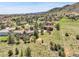 Aerial view of the neighborhood showcasing homes, trees, and mountain views at 10991 Expedition, Littleton, CO 80125